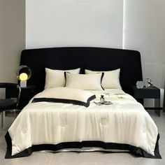 a black and white bed in a bedroom