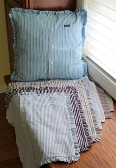 a bed with blue and white pillows on top of it