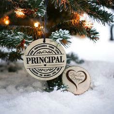 an ornament hanging from a christmas tree in the snow