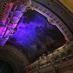 an ornate ceiling with purple and blue lighting