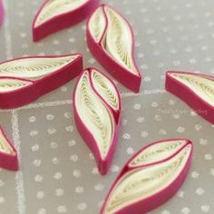 some pink and white leaves on a table