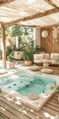 a hot tub sitting on top of a wooden floor next to a white couch and table