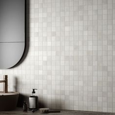 a bathroom with a sink, mirror and soap dispenser on the counter