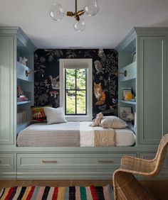 a bedroom with a bed, desk and chair in it next to a wallpapered wall