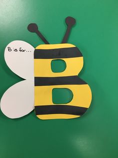 a paper cut out of a bee with the letter b on it's side