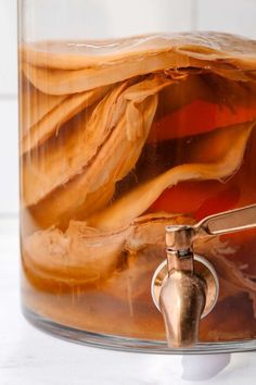 a jar filled with liquid sitting on top of a table