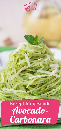 a white plate topped with pasta covered in pesto