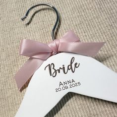 a bride hanger with a pink bow on it