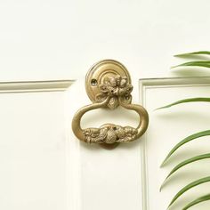 an ornate door handle on a white door