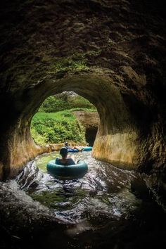 a man in a raft going through a cave