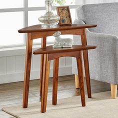 a small wooden table with an elephant figurine on it's shelf next to a chair