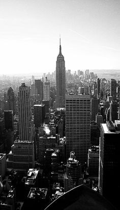 black and white photograph of new york city from top of the rock looking down on empire building