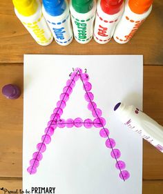 the letter a is made out of colored crayons and paper with markers next to it