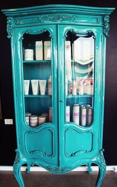 an old china cabinet painted teal green