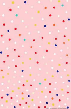 a pink background with multicolored polka dots