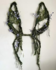 a piece of art made out of moss and flowers