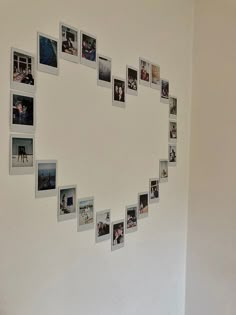 a white wall with many pictures arranged in the shape of a heart