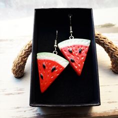 Watermelon earrings.  Cute kawaii fruit earrings. Dangle drop earrings with hypoallergenic stainless steel hooks. Choose between gold or silver steel hooks Vegan /vegetarian and fruit lovers earrings Watermelon measures 3cms long x 2.5cms wide  Total drop length: 5cms Weight: 3.4g  These earrings are carefully shipped in a cardboard box to guarantee you will receive them in perfect conditions. Please specify if you want them as a gift when you are ordering. No additional cost The packaging used Red Fruit Design Drop Earrings, Watermelon Colored Summer Jewelry Gift, Cute Drop Earrings For Summer, Summer Watermelon Colored Jewelry For Gift, Summer Fruit Design Drop Earrings, Trendy Summer Earrings As A Gift, Trendy Summer Earrings As Gift, Trendy Summer Earrings For Gift, Trendy Summer Earrings For Gifts