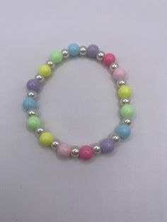 a bracelet with multicolored beads and silver balls