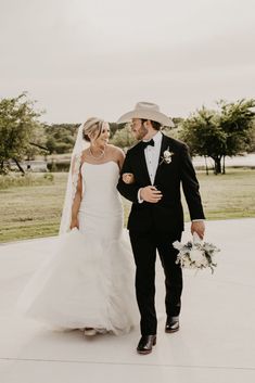 a bride and groom walking down the aisle