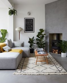 a living room filled with furniture and a fire place