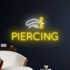 there is a neon sign that says percing on the wall next to a chair