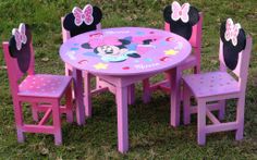 a minnie mouse table and chairs set up in the grass