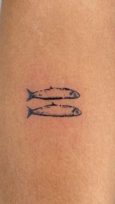 two fish on the back of a woman's thigh