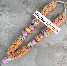 two necklaces made out of flowers and beads with a sign that says vissha divines