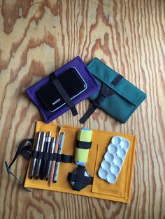 an assortment of items laid out on top of a wooden table next to each other