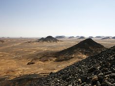 there are many mountains in the desert with no people on them or one person standing on top