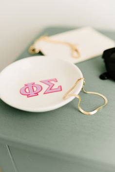 a white plate sitting on top of a green table next to a pair of glasses