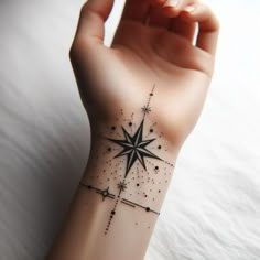 a person's arm with a tattoo on it and a star in the middle