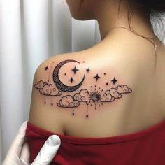 a woman with a tattoo on her shoulder and the moon in the sky above it