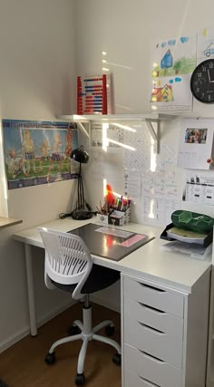 a white desk topped with a laptop computer