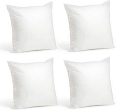 four white pillows sitting next to each other