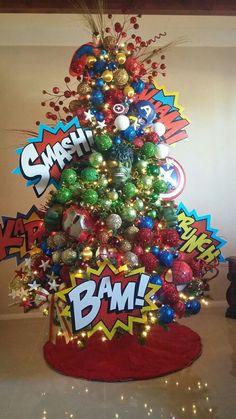 a christmas tree decorated with comic ornaments and baubles is displayed in a room