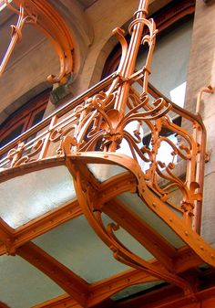 an ornate wooden balcony on the side of a building