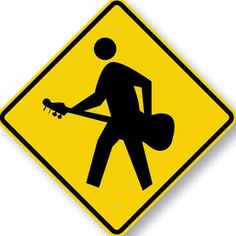 a yellow and black sign with a man holding a guitar in it's hands