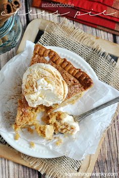 a piece of pie on a plate with ice cream in it and a fork next to it