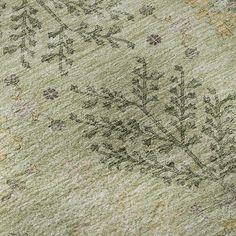 an old rug with green and yellow flowers on it's side, close up