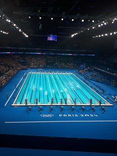 an olympic swimming pool is shown at night