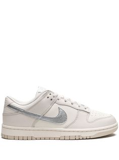 Dunk Low ESS Trend sneakers from Nike featuring ecru, leather, panelled design, signature Swoosh logo detail, metallic effect, round toe, front lace-up fastening, logo patch at the tongue, branded heel counter and flat rubber sole. These styles are supplied by a premium sneaker marketplace. Stocking only the most sought-after footwear, they source and curate some of the most hard to find sneakers from around the world.. Nike Shoes That Go With Everything, New Dunks Low, Women’s Nike Dunks, Nike Dunks Low Neutral, Dunk Low Neutral, Women’s Nike Dunk Low, Trend Sneakers, Basket Style, Metallic Look