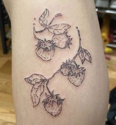 a tattoo on the leg of a woman with strawberries