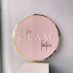 the glam factor sign is on top of a shelf