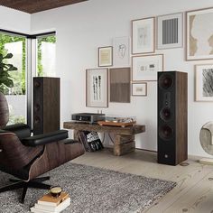 a living room filled with furniture and speakers