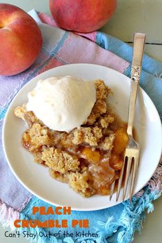 peach crumble pie with ice cream on top and two peaches in the background