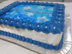 a blue and white cake sitting on top of a table