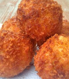 three fried food items sitting on top of a piece of paper