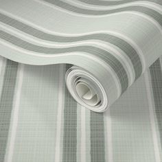 a roll of grey and white striped wallpaper